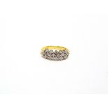 A SIXTEEN STONE DIAMOND 18 CARAT GOLD RING the brilliant cut diamonds totalling approximately 0.64