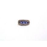 A SAPPHIRE AND DIAMOND RING the five graduated oval cuts enclosed by twenty two single cuts,