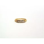 A LATE VICTORIAN FIVE STONE RING stamped '18ct', the graduated old brilliant cuts totalling