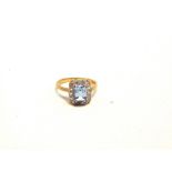 AN AQUAMARINE AND DIAMOND 9 CARAT GOLD CLUSTER RING the rectangular cut stone enclosed by fourteen