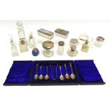 A CASED SET OF SIX SILVER TEASPOONS with sugar tongs; with seven toilet bottles with silver