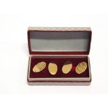 A PAIR OF 9 CARAT GOLD CUFFLINKS London 1968, one diamond cut oval panel with chain connector to a