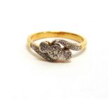 A THREE STONE DIAMOND ILLUSION SET RING stamped '750', finger size N, 3.2g gross, cased