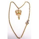 AN EDWARDIAN PERIDOT AND SEED PEARL PENDANT stamped '9ct', on a fancy link chain, 36cm long