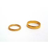 A 22 CARAT GOLD WEDDING RING with another 11g gross