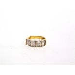 A DIAMOND SET DRESS RING stamped '18k', composed of four groups of five baguettes with a quartet