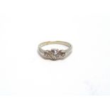 A THREE STONE DIAMOND RING the three old brilliant cuts totalling approximately 0.4 carats, in an