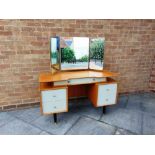A G-PLAN DRESSING TABLE with triple mirror, long drawer with gold stamped 'G-PLAN' label over two