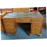 A WALNUT RECTANGULAR TWIN PEDESTAL WRITING DESK with inset leather top above three frieze drawers