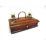 AN EDWARDIAN OAK DESK STAND fitted with two glass inkwells, 28cm wide; together with a set of oak