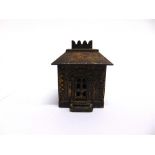 A NORTH AMERICAN CAST IRON MONEY BANK 19th century, in the form of a Bank building, with remains