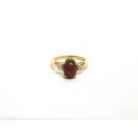 A BLACK OPAL 9 CARAT GOLD RING with a trio of stones to each shoulder, finger size N1/2, 2.2g gross