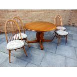 AN ERCOL 'GOLDEN DAWN' extending circular dining table 115cm diameter, together with matching set of