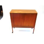 A TEAK CABINET WITH TAMBOUR FRONT DOOR 80cm wide, together with a nest of three teak coffee tables