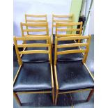 A SET OF SIX BEECH FRAMED LADDERBACK CHAIRS with black vinyl seats