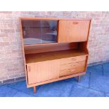 A SCHREIBER FORMICA DRESSER the upper section with sliding glass doors and drop-down cupboard, the