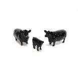 A BESWICK FAMILY GROUP OF ABERDEEN ANGUS CATTLE comprising bull and cow model 1562 and 1563, both