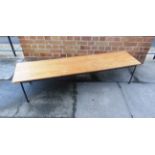 A LOW RECTANGULAR TEAK COFFEE TABLE with metal base, 153cm long 38cm deep 32cm high, together with a