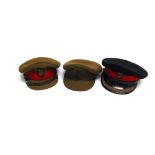 THREE BRITISH ARMY OFFICER'S PEAKED CAPS including one khaki cap with a field service Royal