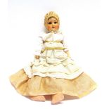 A SCHOENAU & HOFFMEISTER COMPOSITION SOCKET-HEAD DOLL with a cropped light brown wig, sleeping