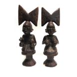 TRIBAL ART - A PAIR OF CARVED WOODEN STYLIZED MALE & FEMALE FIGURES probably Nigerian Yoruba Sango