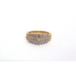 A 9 CARAT GOLD THIRTY SEVEN STONE DIAMOND DRESS RING set with three graduated lines of brilliants