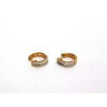 A PAIR OF 9 CARAT GOLD HALF HOOP DIAMOND EARRINGS each set with a central row of baguettes with