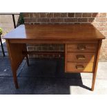 A HEALS WALNUT SINGLE PEDESTAL TABLE with three drawers, ivorine label for 'HEALS TOTTENHAM COURT