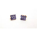 A PAIR OF TANZANITE EARSTUDS stamped '9k', set with six oval cuts to each, 0.9cm long, 1.9g gross