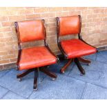 A PAIR OF SWIVEL OFFICE CHAIRS with tan leather upholstered and studded seats and backrests, 83cm