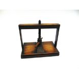 A 19TH CENTURY TABLE TOP LINEN OR BOOK PRESS the plate 20cm x 32cm the frame (excluding wooden
