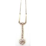 AN EDWARDIAN DIAMOND DROP PENDANT the seven stone flower head cluster to an eight graduated stone