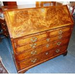 A GEORGE III WALNUT BUREAU the fall front with fitted interior, the two short and three long