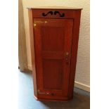 AN ARTS AND CRAFTS STYLE OAK HANGING CORNER CUPBOARD the panelled door with brass strap work