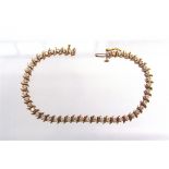 A 9 CARAT GOLD FORTY EIGHT STONE DIAMOND LINE BRACELET the brilliant cuts totalling approximately