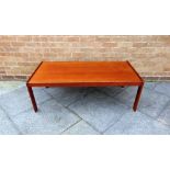 A LARGE DANISH TEAK COFFEE TABLE the rectangular top 66cm x 129cm, 44cm high, labelled 'MADE IN