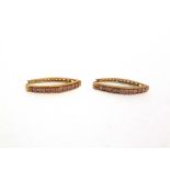 A PAIR OF 9 CARAT GOLD LONG HOOP TINTED DIAMOND EARRINGS each set with eleven brilliant cuts, the