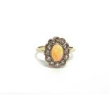 AN OPAL AND DIAMOND CLUSTER RING the white mount stamped '18ct' and Pt', the oval cut cabochon