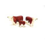 A BESWICK FAMILY GROUP OF HEREFORD CATTLE the bull 1363A and cow 1360 both stamped 'CH. OF