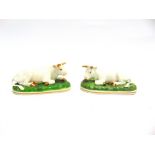A PAIR OF ENGLISH PORCELAIN GROUPS OF SEATED CATTLE with gilt decoration, on naturalistically