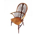 A WINDSOR STICK BACK ELBOW CHAIR with wheel back splat and dished seat