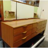 A FORMICA DRESSING CHEST with triple mirror above nine drawers on sledge feet, 151cm wide 45cm