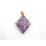 A 9 CARAT GOLD TANZANITE CLUSTER PENDANT of lozenge shape, 3.1cm long excluding the bale, 4g gross