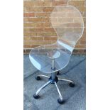 A CLEAR PERSPEX OFFICE SWIVEL CHAIR with gas lift rise and fall action, on five prong chrome base