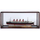 A MODEL OF THE CUNARD PASSENGER LINER 'R.M.S. LUSITANIA' of plastic construction, set to a wooden