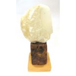 A LARGE CARVED QUARTZ SCULPTURE modelled as a stylised head on wooden base, 62cm high overall