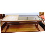 A SMOKED GLASS AND TILE TOP COFFEE TABLE 121cm long 50cm deep 46cm high; together with a matching