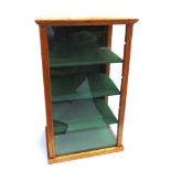 A TABLE TOP CABINET glazed to three sides, with three adjustable felt-covered shelves, 59cm high,