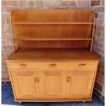 A LIGHT ERCOL STYLE DRESSER the rack with two shelves, above base with three drawers and cupboard