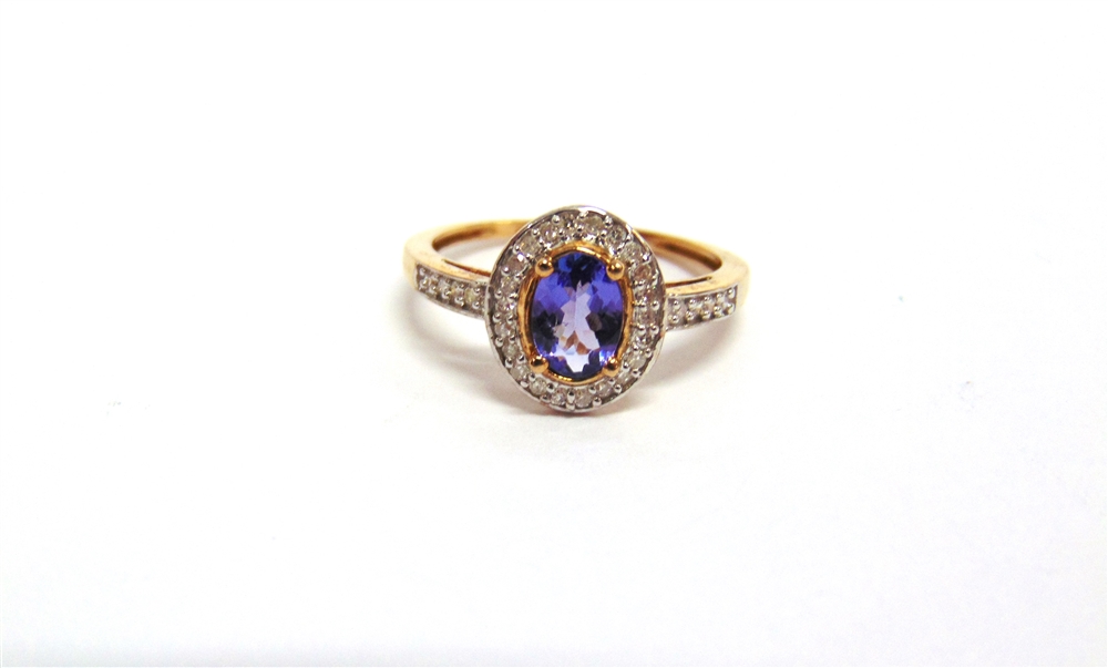 A 9 CARAT GOLD TANZANITE AND DIAMOND CLUSTER RING the oval cut enclosed by single cuts and single